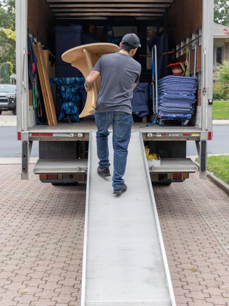 Professional mover carrying furniture